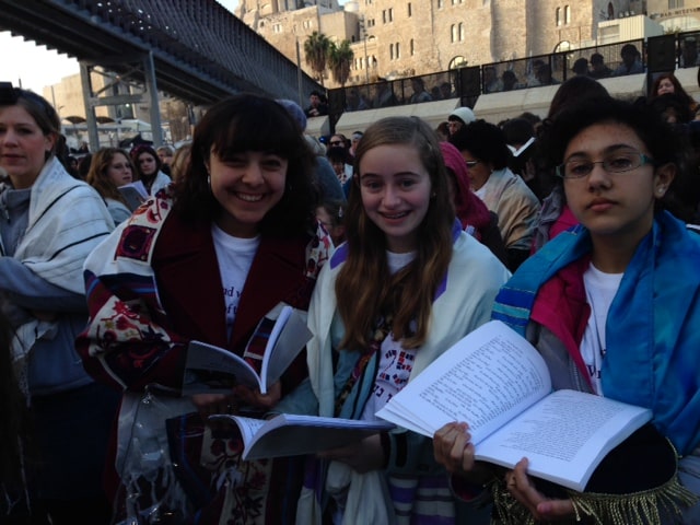Eliza Moss-Horwitz, Lucy Sattler and Alexandra Schwartz stand in prayer at the Kotel.